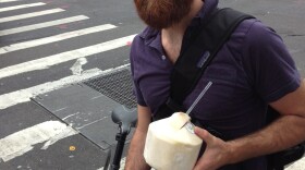 John Gordon Gauld, a 35-year old artist, bikes with coconut water in New York City.