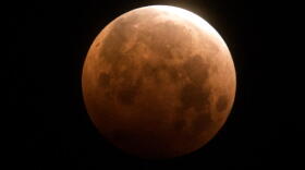 The total lunar eclipse is seen over Santa Monica Beach in Santa Monica, Calif., Wednesday, May 26, 2021. (Ringo H.W. Chiu/AP)