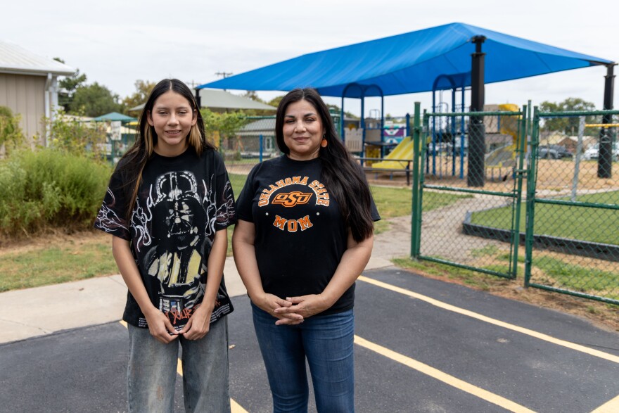 12-year-old Wahreshe Hamilton and her mom, Geneva HorseChief Hamilton, stand outside the playground at Dapsoka Ahnkodapi on Aug. 17. Dapsoka was the Osage Nation's private school that was recently closed by the tribe's executive branch.