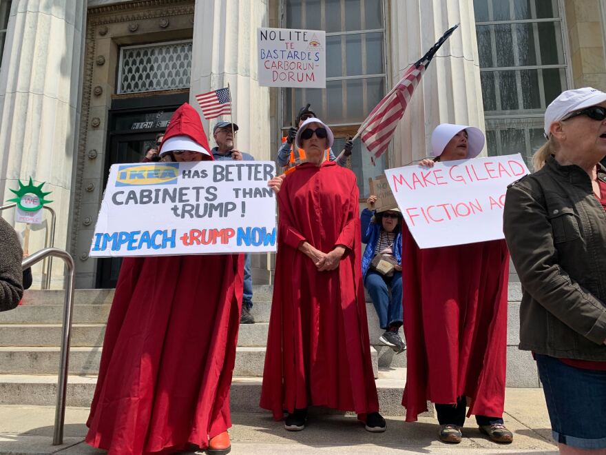 Protesters in Westerly dressed up as “handmaids” from the television show and Margaret Atwood novel “The Handmaid’s Tale.” One holds a sign reading “Make Gilead fiction again,” in reference to the story’s fictional dystopian society where women are forced to bear children.