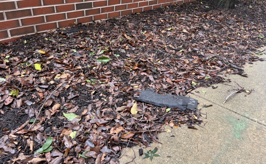 A roof shingle on the ground outside ISU's Fell Hall.