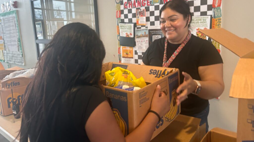 Kirk Elementary community school coordinator Miriam Chavez hands a box of food to a Gaston Middle school student on Feb. 24, 2026, at the middle school. Both schools are in the Fresno Unified School District. The food distribution event, for families from both schools, provided food to 66 households, which included 142 adults and 184 children.
