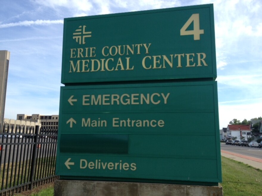 A green and white Erie County Medical Center sign.