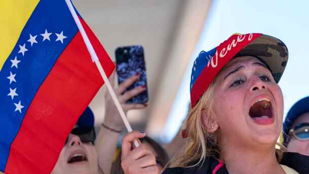 A woman waving a flag celebrates after President Donald Trump announced Venezuelan President Nicolás Maduro had been captured and flown out of the country, Saturday, Jan. 3, 2026.