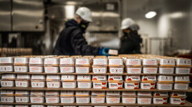 Stacks of packaged Ithaca Humus are shown in the company's production facility.