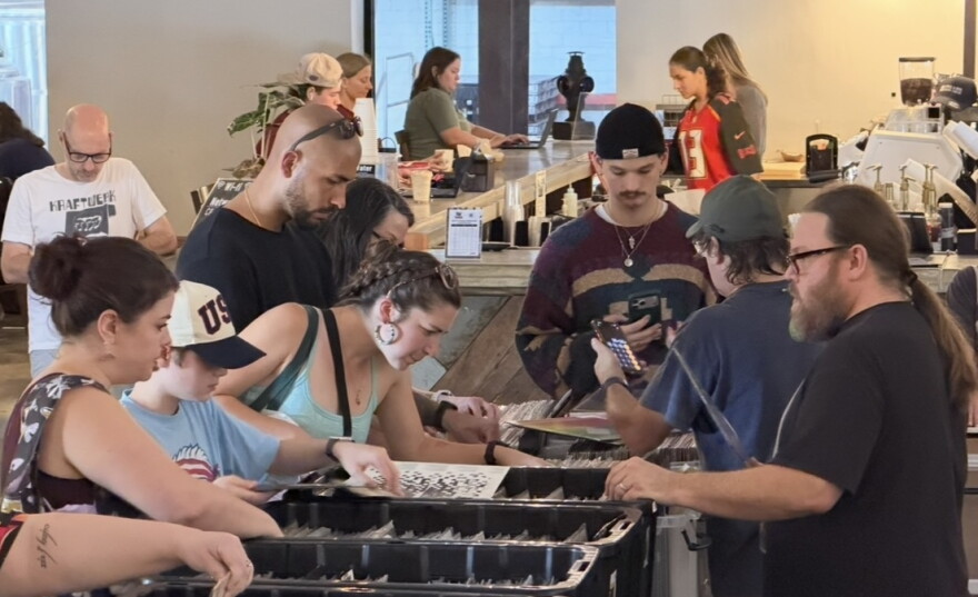 Attendees browse dozens of bins of records at the Gainesville Record Fair in Cypress & Grove Brewing Co. on Sunday.