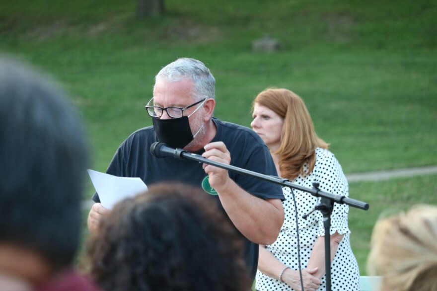 East Bluff resident Lawrence Maushard gives a prepared speech in favor of keeping an amphitheater in Glen Oak Park. Park District Executive Director Emily Cahill listens in the background.