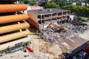 Demolition crews tear down the former Spartan Bookstore in East Lansing, Mich., on Sept. 14, 2026. A new apartment high-rise will be built on the site.