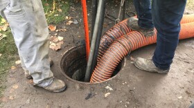 An Anchorage Water and Wastewater crew cleans a sewer pipe in East Anchorage on Sept. 10, 2019. (Photo by Kirsten Swann/Alaska Public Media)