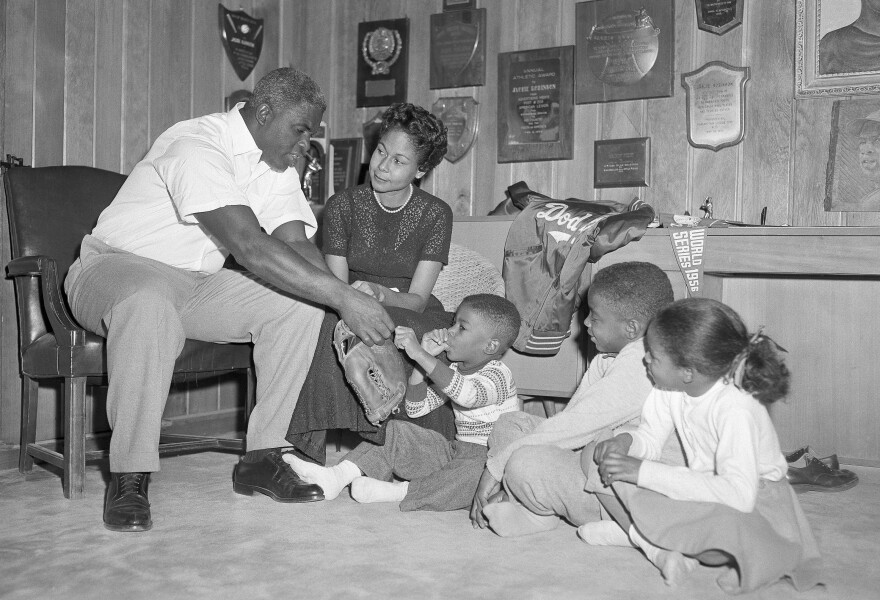 Jackie Robinson and his family sit in the trophy-decorated den of their home in January 1957. From left, Jackie, Rachel, David, Jackie Jr. and Sharon.