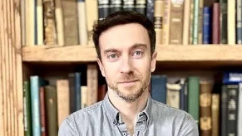 A man poses for a direct head shot.