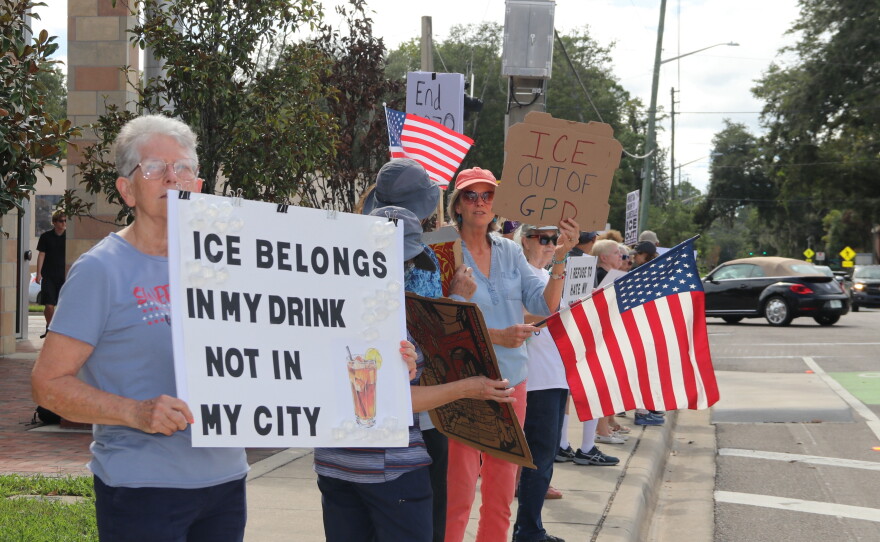 Valerie Fuldauer, 76, holds a sign with the words “ICE belongs in my drink not in my city.” (María Sofía Rodríguez/WUFT News)