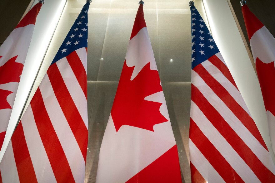 FILE - U.S. and Canadian flags are displayed before an event with Ontario Premier Doug Ford and the U.S. Chamber of Commerce, Tuesday, Feb. 11, 2025, in Washington. (AP Photo/Mark Schiefelbein, File)