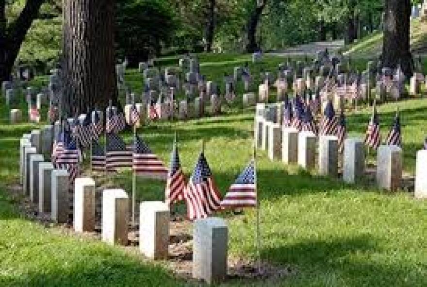 cemetery with headstones and American flags