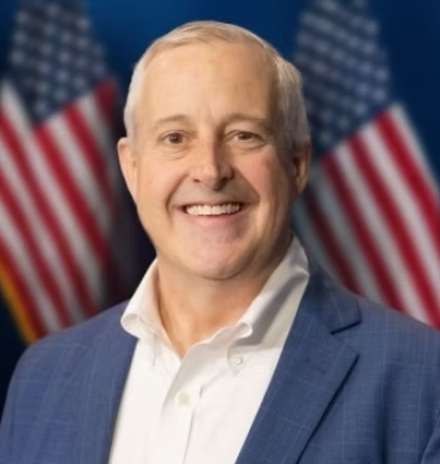 Man in front of American flag