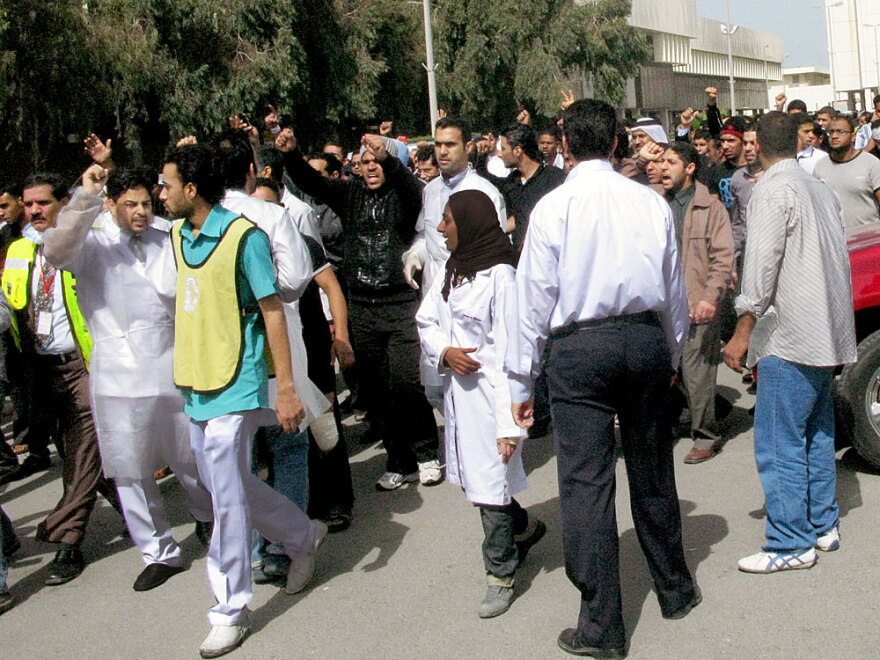 Nurses and medical workers march in protest, demanding the resignation of the health minister, after ambulances were blocked from reaching the wounded during Thursday's violent crackdown in Pearl  Square.