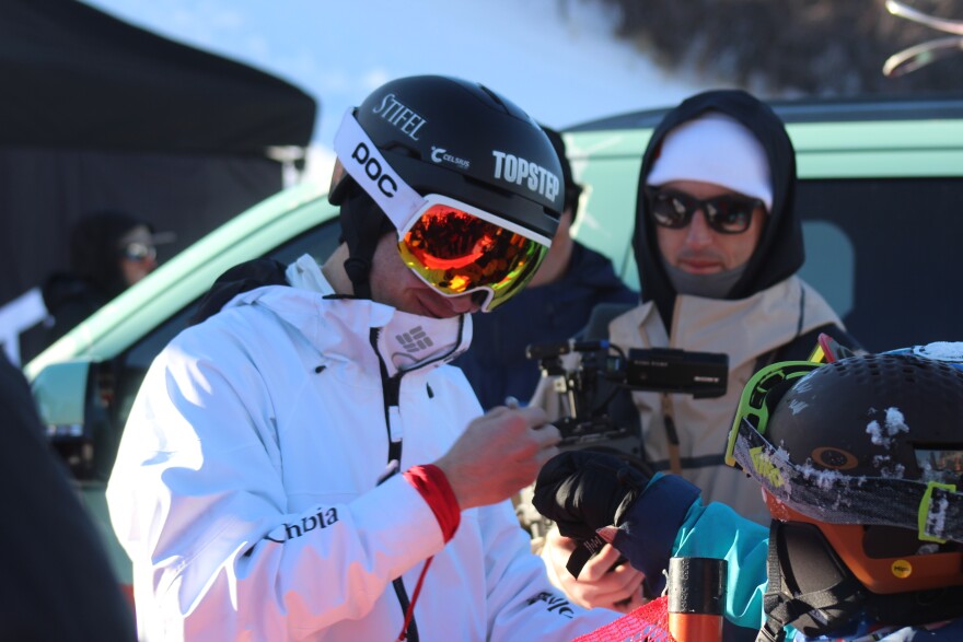 Alex Ferreira signs jackets and helmets following the freeski halfpipe finals on Saturday, January 10, 2025, at Buttermilk Mountain.