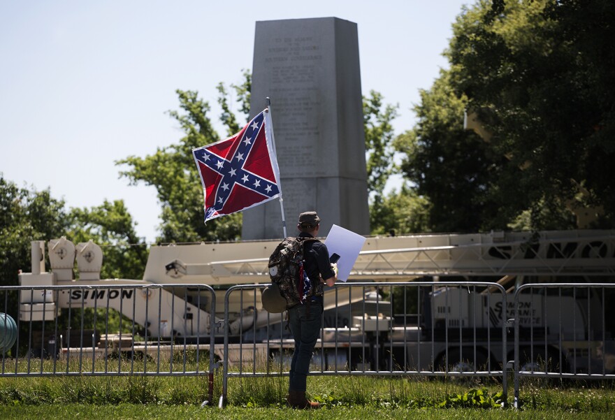 Brendan Koch, of Arnold, Missouri, looks at the Confederate Memorial after crews removed the top of it Thursday morning. June 8, 2017