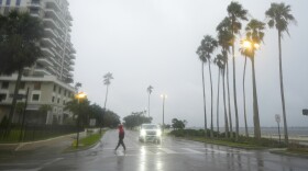 A person walks in rain.