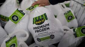 A shopper checks premium frozen young turkey at a grocery store in Glenview, Ill., Monday, Nov. 25, 2024. (Nam Y. Huh/AP)