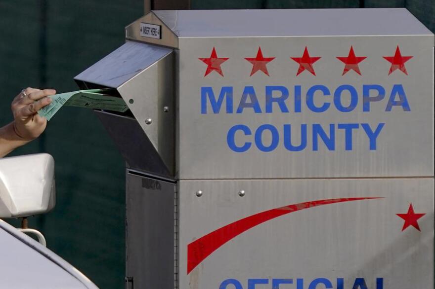 A voter casts their ballot at a secure ballot drop box at the Maricopa County Tabulation and Election Center in Phoenix, Tuesday, Nov. 1, 2022.