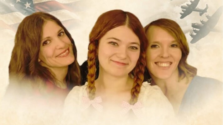 Three women in front of an American flag and war planes
