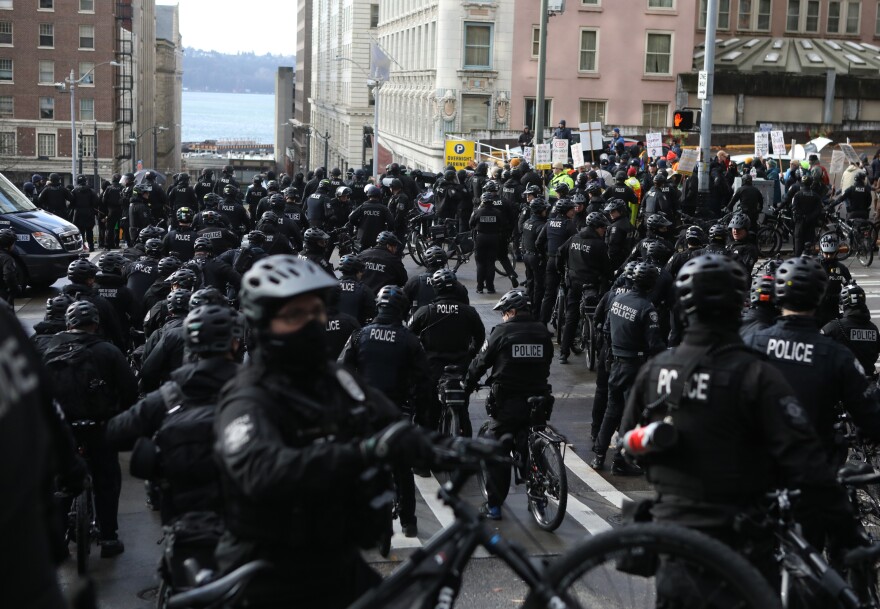 Seattle police officers on bicycles confront protesters during the United Against Hate rally in Seattle last month.