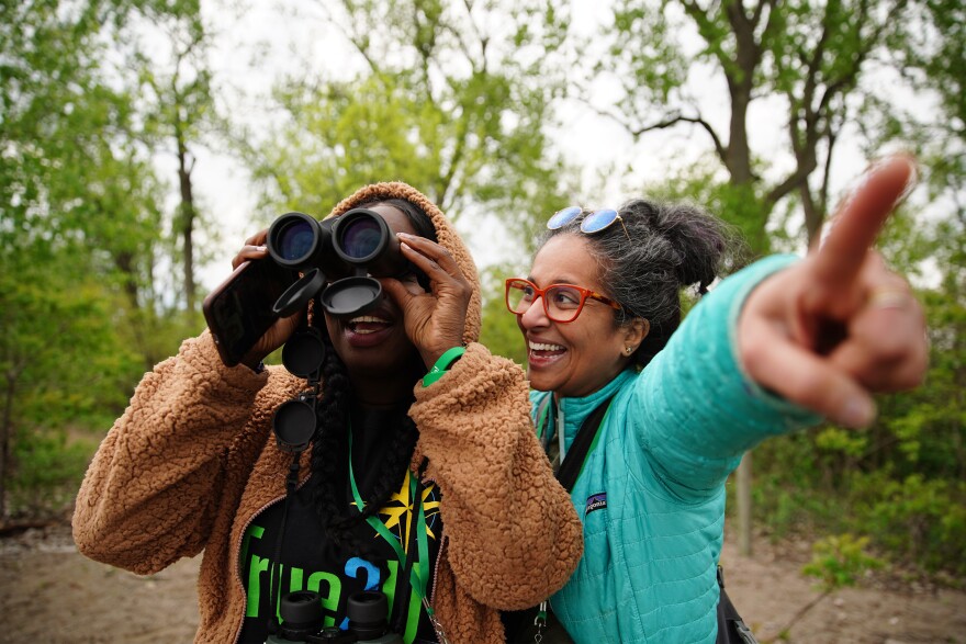 Divya Sridhar (right) helps India Hobbs spot a bird at the Magee Marsh Wildlife Area in Ottawa County, Ohio, on Friday, May 3, 2024.