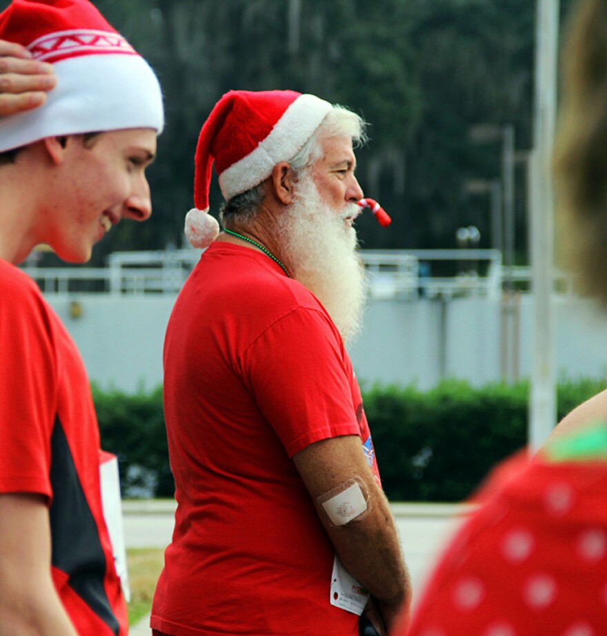 Michael Moore of Bell, Florida, awaits the start of the Tacky Sweater Holiday 5K at the University of Florida on Saturday, Dec. 6, 2014, in his Santa-inspired outfit. His wife, Sandy Moore, joked that people call him "Nick" because of his look.