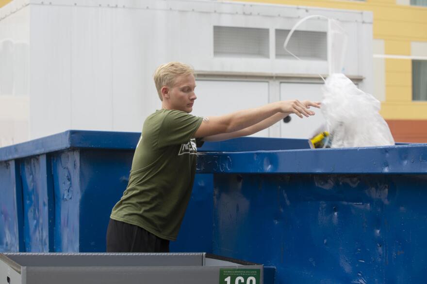 Matthew Williams throwing garbage away