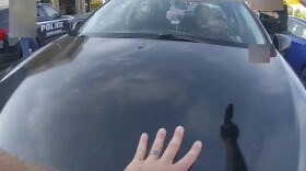 FILE - This image from bodycam video released by the Blendon Township Police on Friday, Sept. 1, 2023, shows an officer pointing his gun at Ta'Kiya Young moments before shooting her through the windshield outside a grocery store in Blendon Township, Ohio, a suburb of Columbus, on Aug. 24. The pregnant Black mother was pronounced dead shortly after the shooting. Her unborn daughter did not survive. The image was pixelated by the source. (Blendon Township Police via AP, File)