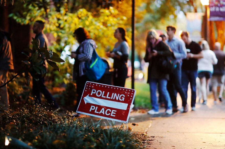 A line forms outside a polling site on election day in Atlanta on Tuesday. More than 47 percent of the voting-eligible population cast a ballot in the midterm elections on Tuesday according to early estimates from the United States Election Project.