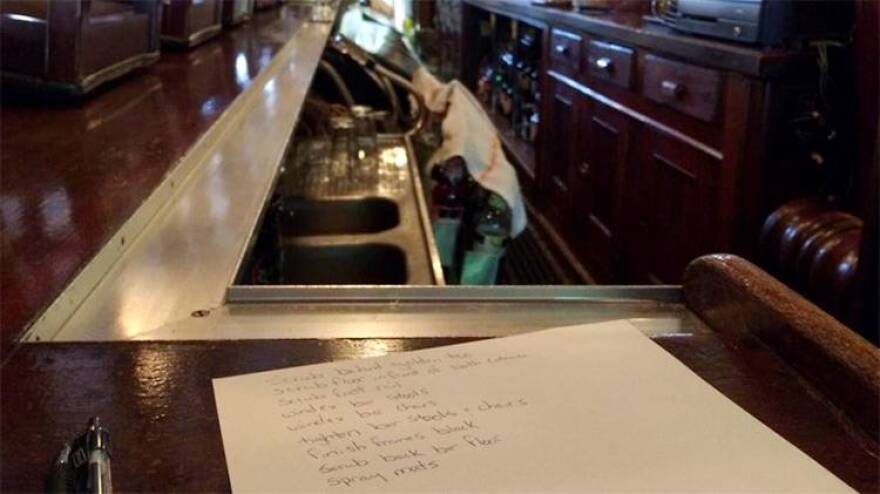 A list of cleaning tasks sits on the bar of the Knickerbocker Saloon.
