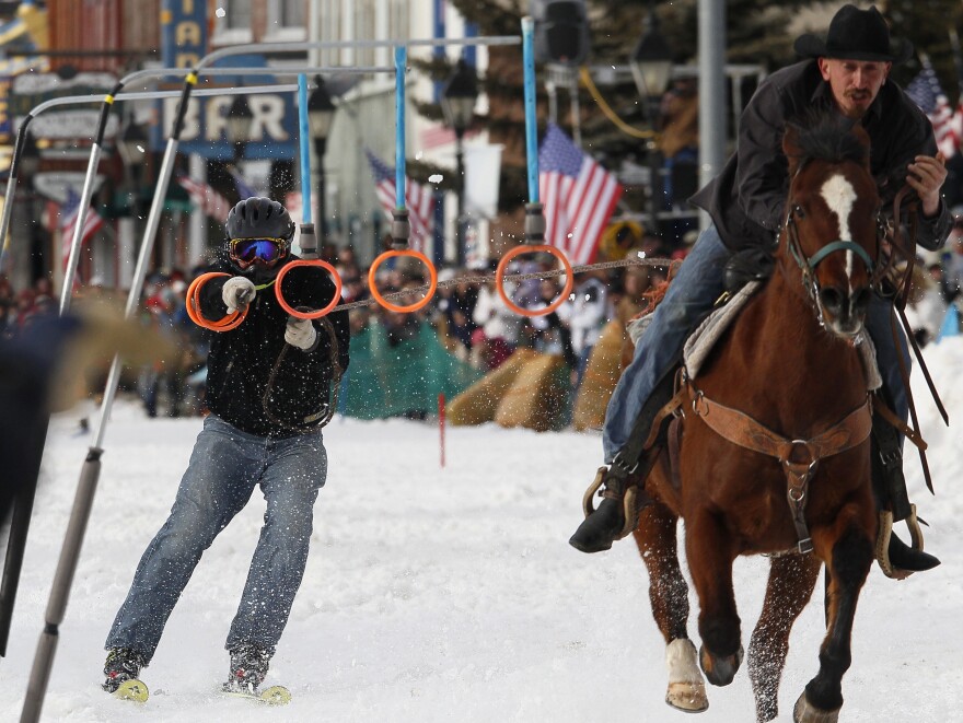 A horseman pulls a skier down the street in Leadville, Colo., in March, during the city's annual skijoring event. It was the event's 62nd year.