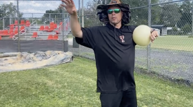 Trenton Head Coach Chris Marlo instructs his players on how to properly use the Connection Ball, one of the training tools his Tigers use. Marlo uses his expertise in physical therapy and his coaching experience to educate high school and travel ballplayers on proper arm care techniques. (Ethan Eibe/WUFT News)