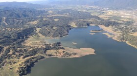 A lake surrounded by mountains and wilderness, seen from above.