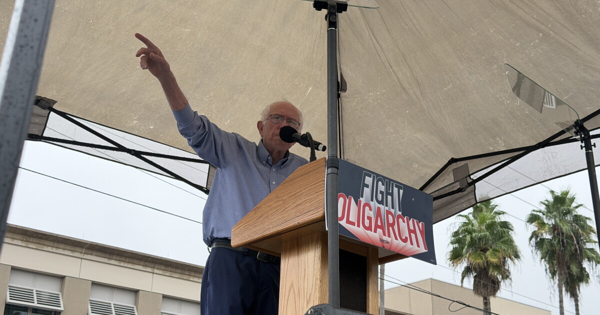 Photo: WUSF Man gesturing under a tent