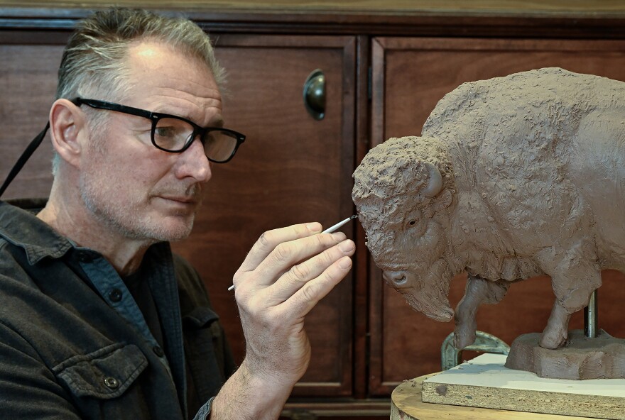 With a delicate hand, Staab adds detail to a replica of the bison he is creating for museum donor Naoma Tate who funded the bison project for the museum.