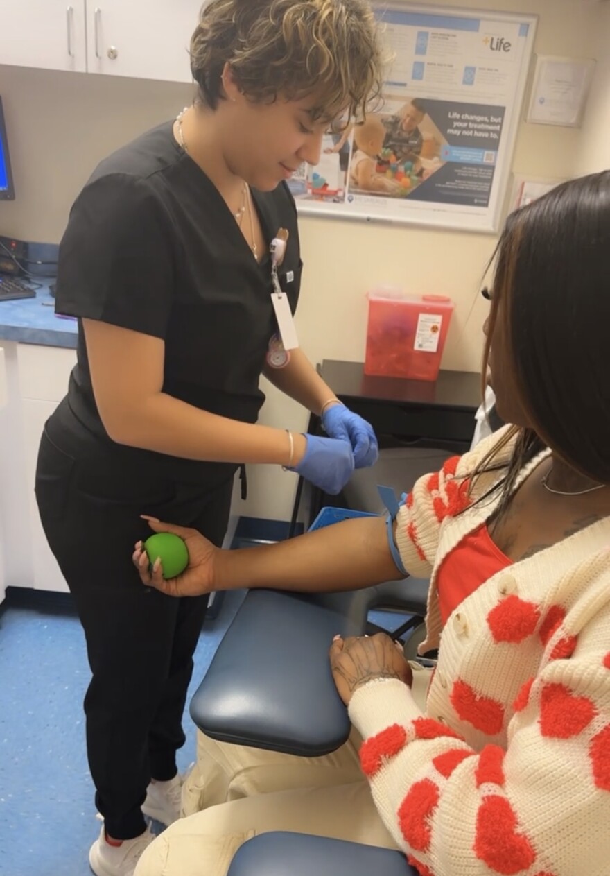 A staff member at ETSI Health Clinic prepares a patient for blood work during an appointment in Portsmouth.