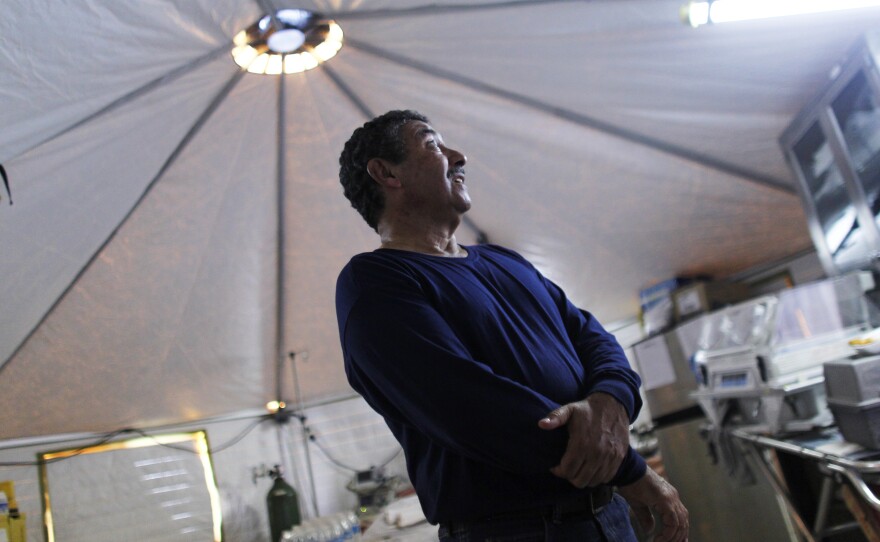 Dr. Jose Carrasquillo works in the clinic run out of military-style tents, which does not have the equipment that would be standard in most hospitals.