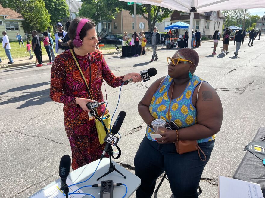 Reporter Maayan Silver talks with a community member at the Heal the Hood block party.