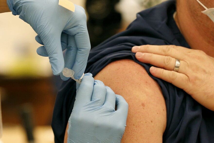 A Pfizer-BioNTech COVID-19 vaccine is given to an Ohio State employee on Dec. 14, 2020, in Columbus, Ohio. (Jay LaPrete/AP)