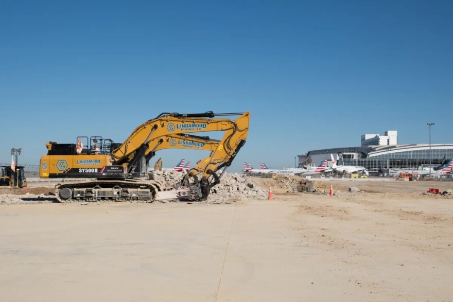 Cranes dig into the ground at DFW Airport.