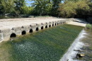 Water flows through a low-head dam.