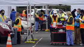 Wake County Health Department workers along with nurses and volunteers from area hospitals and emergency services are seen during a drive through COVID mass vaccination event at PNC arena in Raleigh, N.C., Thursday, Feb. 11, 2021. Since North Carolina began administering the vaccine in December, more than 1 million people have gotten their first doses. 