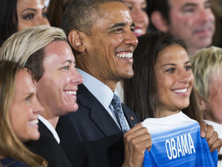 President Barack Obama with Christie Rampone (left) Abby Wambach (center), and Carli Lloyd (right) at the White House.
