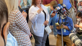 IIP client Marilyn Mulero, fully exonerated, speaks to press at the Cook County Courthouse in Chicago; to the left is IIP Co-Director Lauren Kaeseberg.