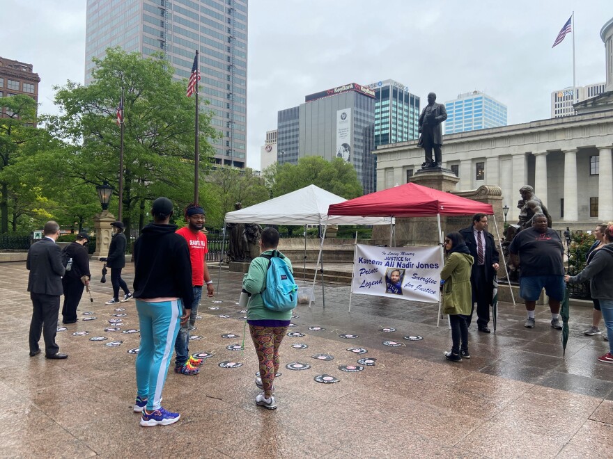 Activists gather at the Ohio Statehouse to announce they've filed petitions for a ballot issue to qualified immunity for law enforcement and other public workers. The records on the ground bear the names of people killed in shootings by police officers.