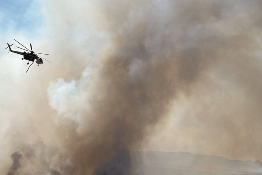 This undated photo provided by the U.S. Forest Service on Aug. 3, 2026, shows a helicopter fighting the Widemouth 2 wildfire burning in the Fishlake National Forest.