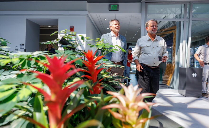 Michigan State University President Kevin Guskiewicz, left, and U.S. Sen. Gary Peters, right, visit the Facility for Rare Isotope Beams in East Lansing, Mich., on Aug. 28, 2026. The visit was the last stop on Peters' final motorcycle tour of Michigan as senator.